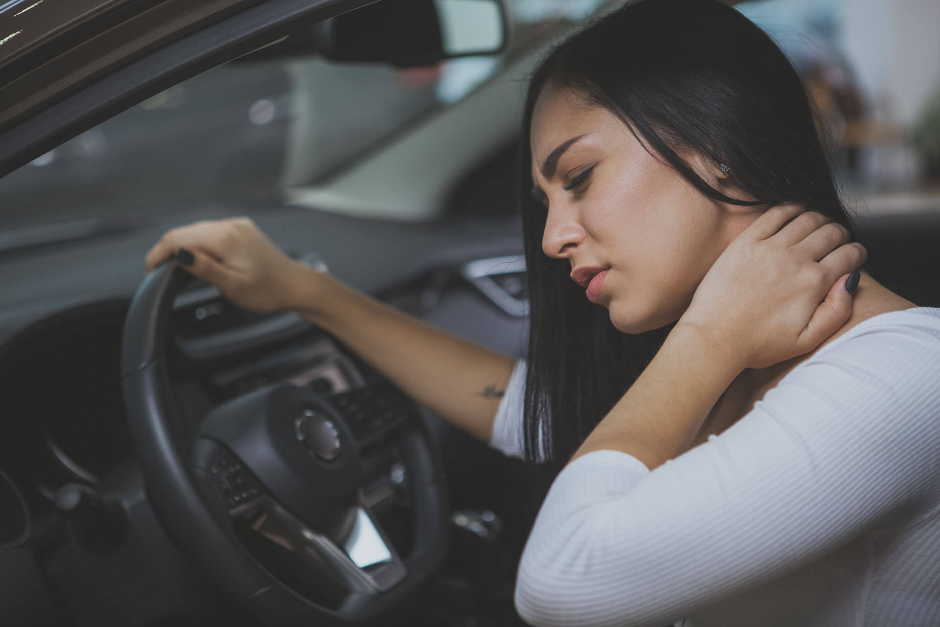 Female driver having terrible neck pain after whiplash injury in car crash Female driver having terrible neck pain after whiplash injury in car crash